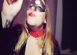 Blond-haired zoophilic vixen in a mask blows a black mutt happily